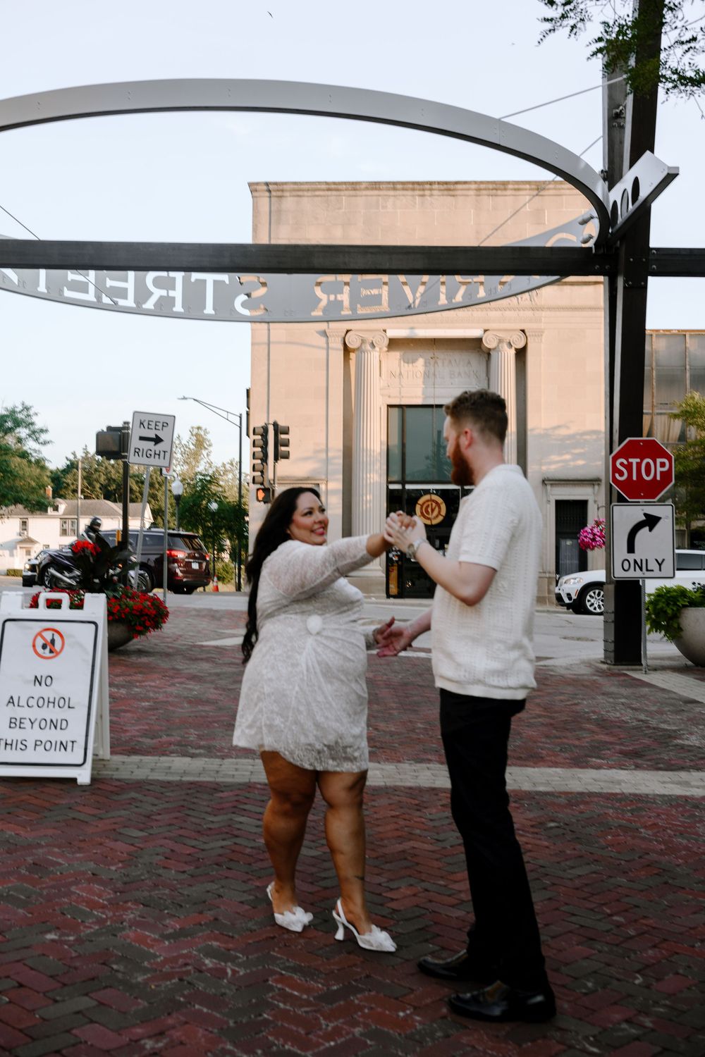 A sequence of dance moves on a brick patio near a stop sign during an outdoor celebration.