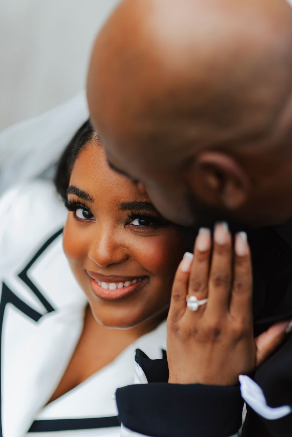Close up of an intimate engagement moment showing a beautiful smile and sparkling diamond ring.
