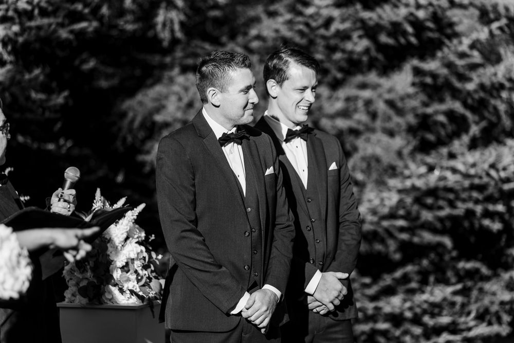 Black and white wedding photos show intimate moments between couples during an outdoor ceremony in a garden setting.