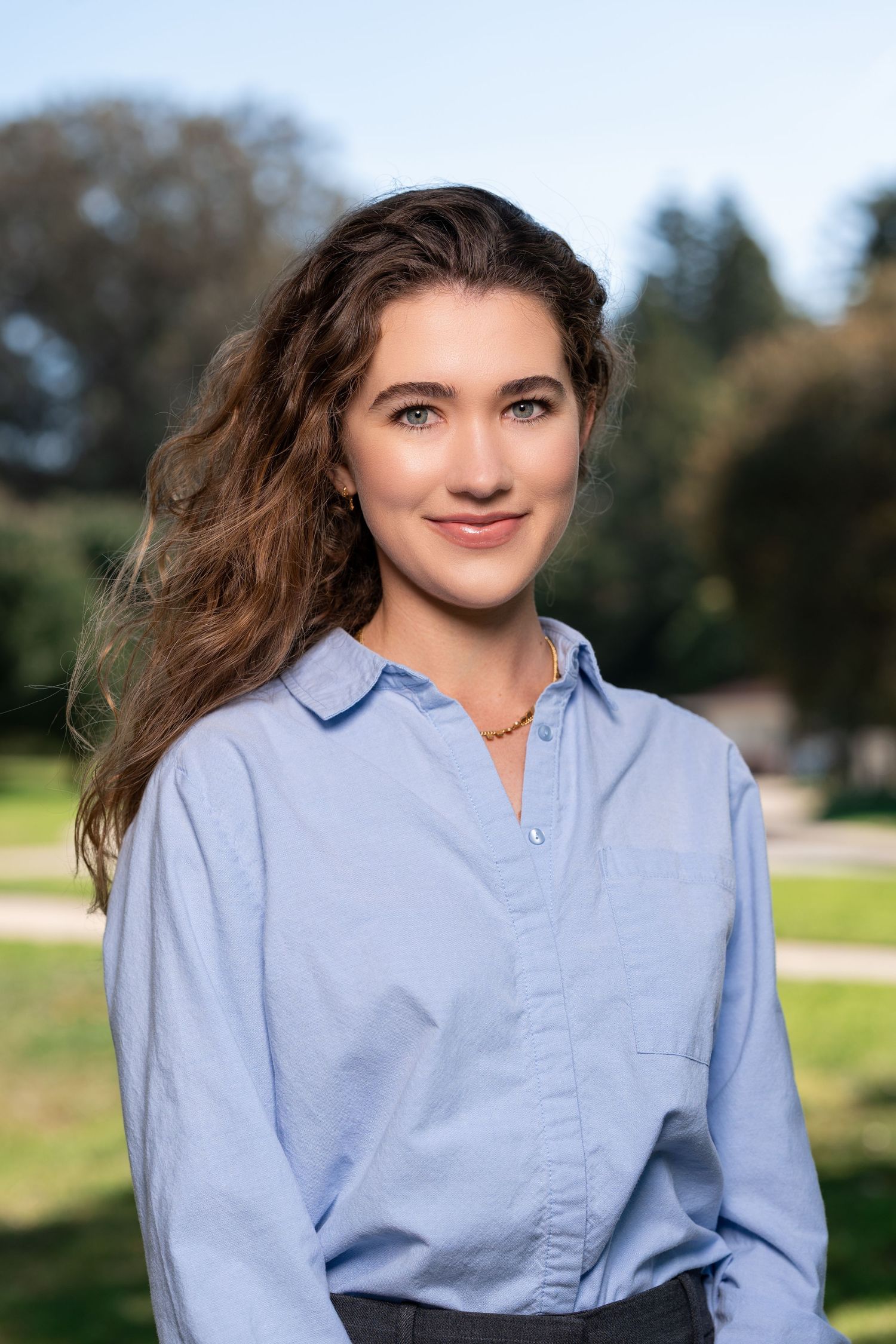 A series of photos showing someone in a light blue button-down shirt posing outdoors against a natural background.