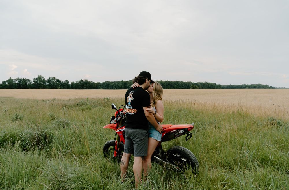 A series of images showing a motorcycle parked in a grassy field with people relaxing and enjoying the scenery.
