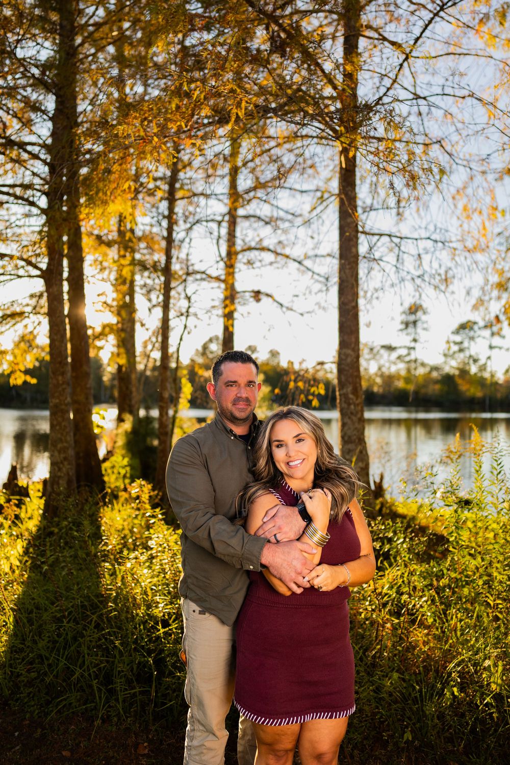 Sunset family photoshoot by the lake with warm autumn lighting.