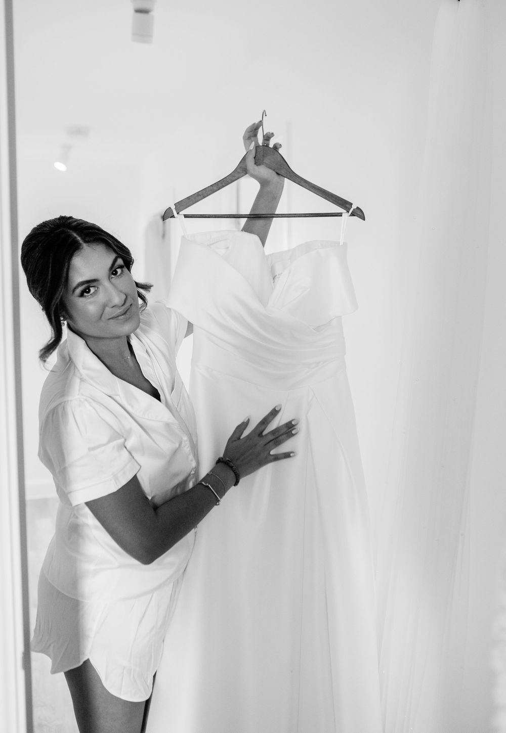 Series of black and white photos showing wedding dress preparation.