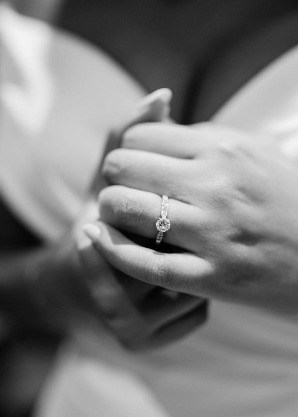 Detailed black and white photos of engagement rings and wedding bands.