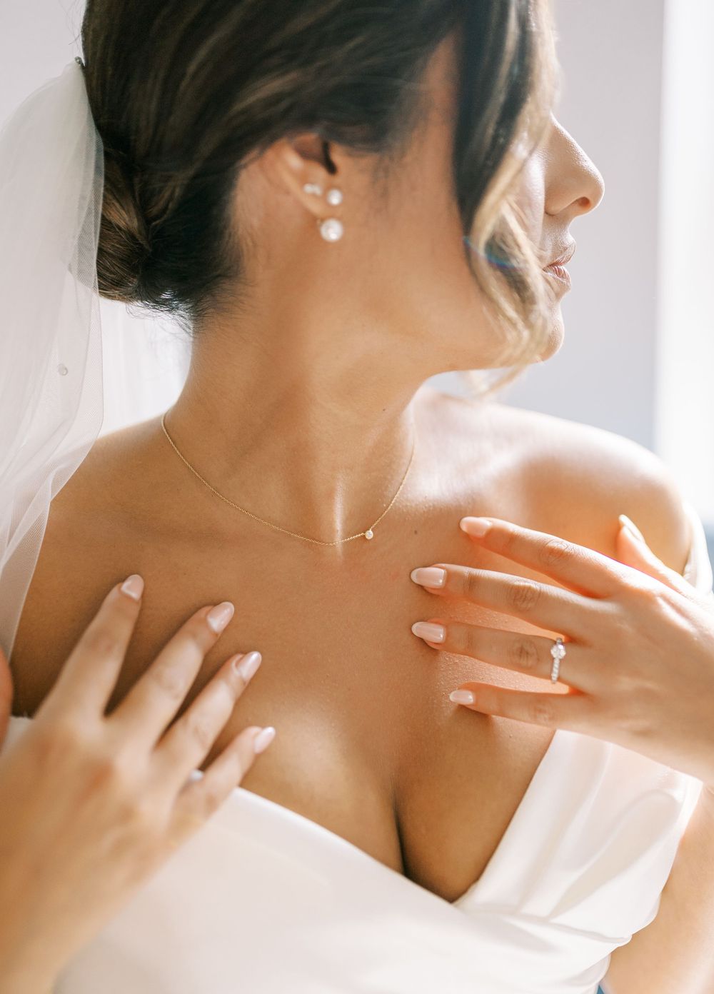 Elegant bridal portrait highlighting bare shoulders and delicate veil details.