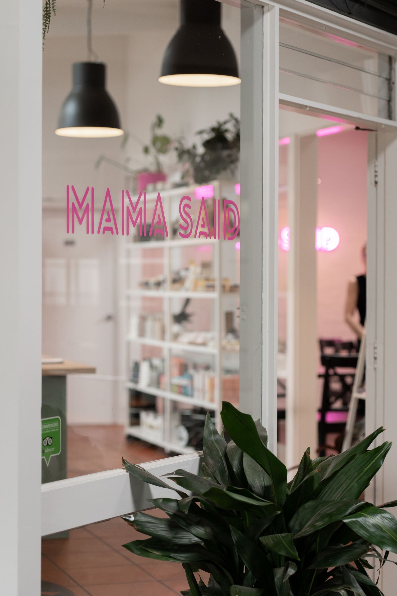 Retail display shelves showcasing beauty products, perfumes, and skincare items in a boutique store setting.