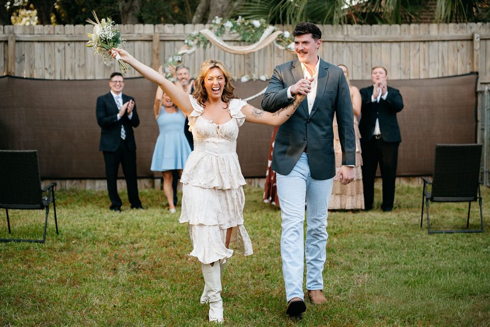 Best affordable micro wedding photoghapher in Fort Walton beach. Couple celebrating their marriage with family in the backyard at home