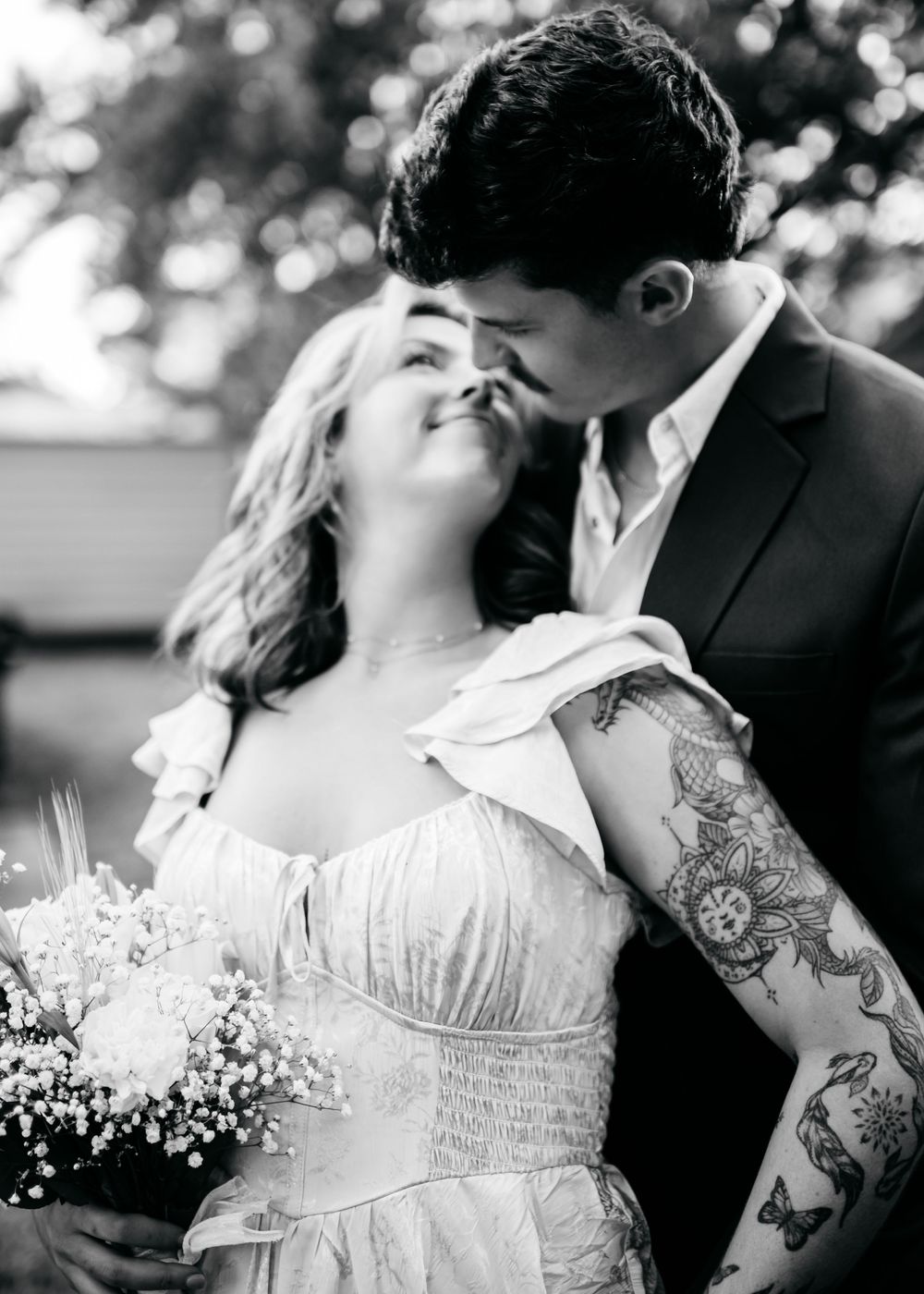 A romantic black and white wedding photo collage showing intimate moments between a couple in formal attire.