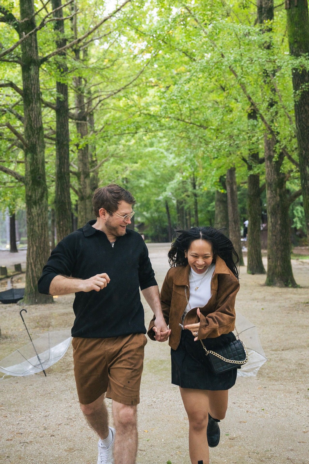A series of four photos showing playful movements in a wooded park setting with fall foliage in the background.