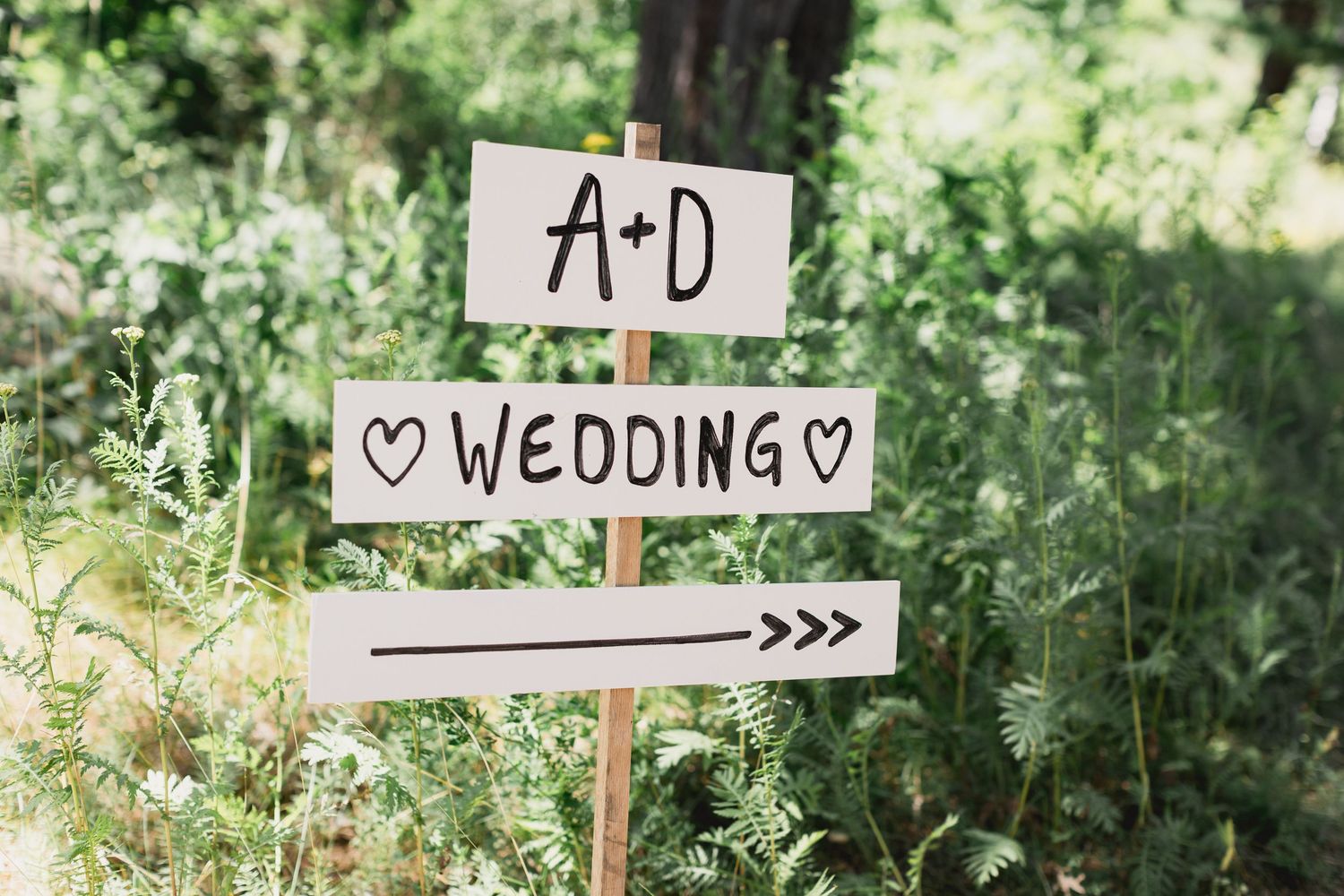 A couple shares their first look moment in a wooded outdoor setting during their wedding ceremony.