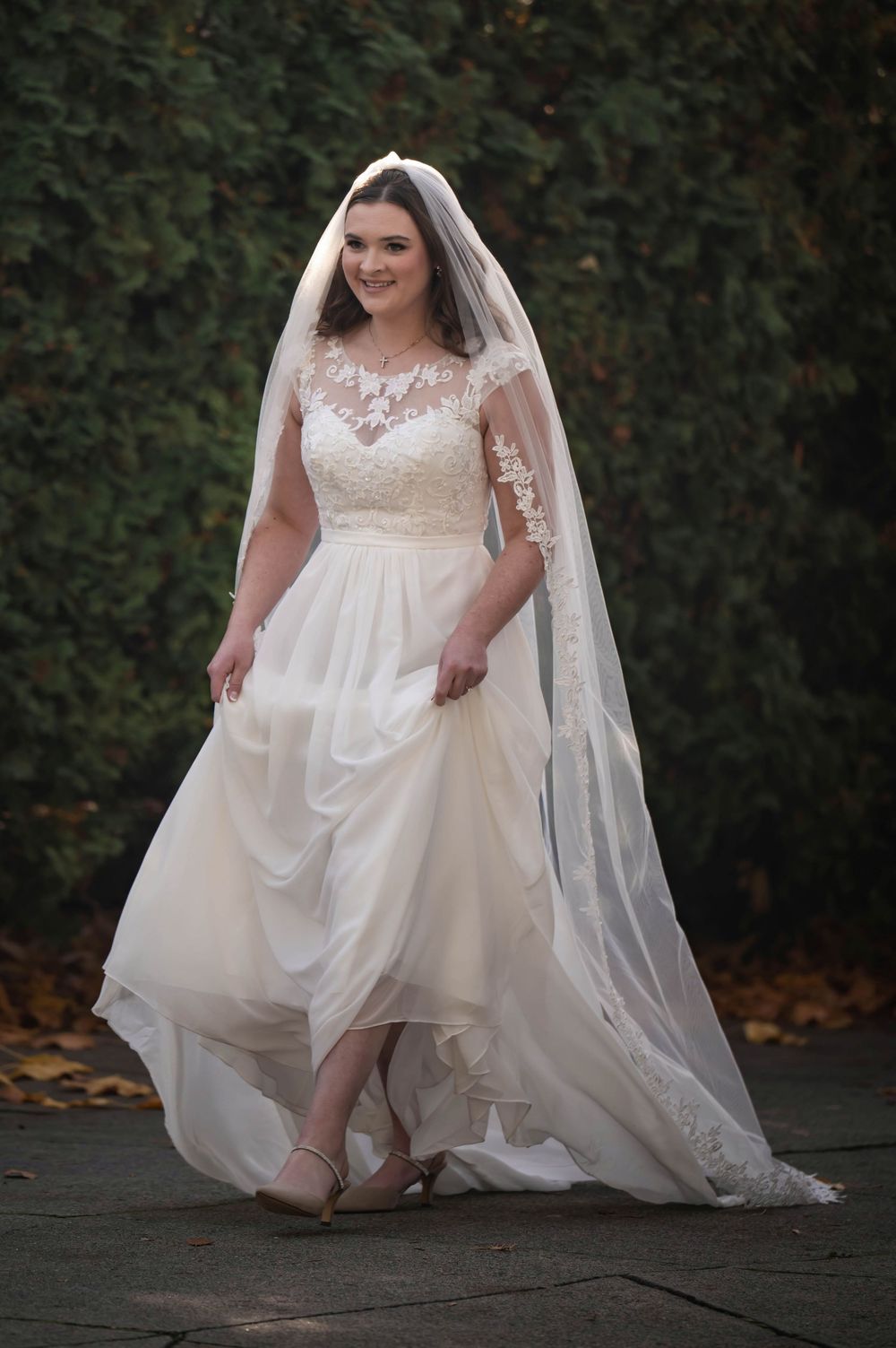 A dreamy photo of a bride walking down the aisle in her wedding dress at the Roberts Mansion in Spokane Washington.