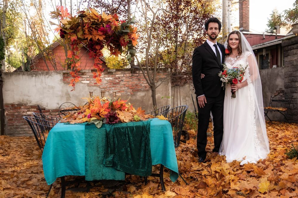A dreamy fall photo of a bride and groom outside the Roberts Mansion in Spokane Washington.
