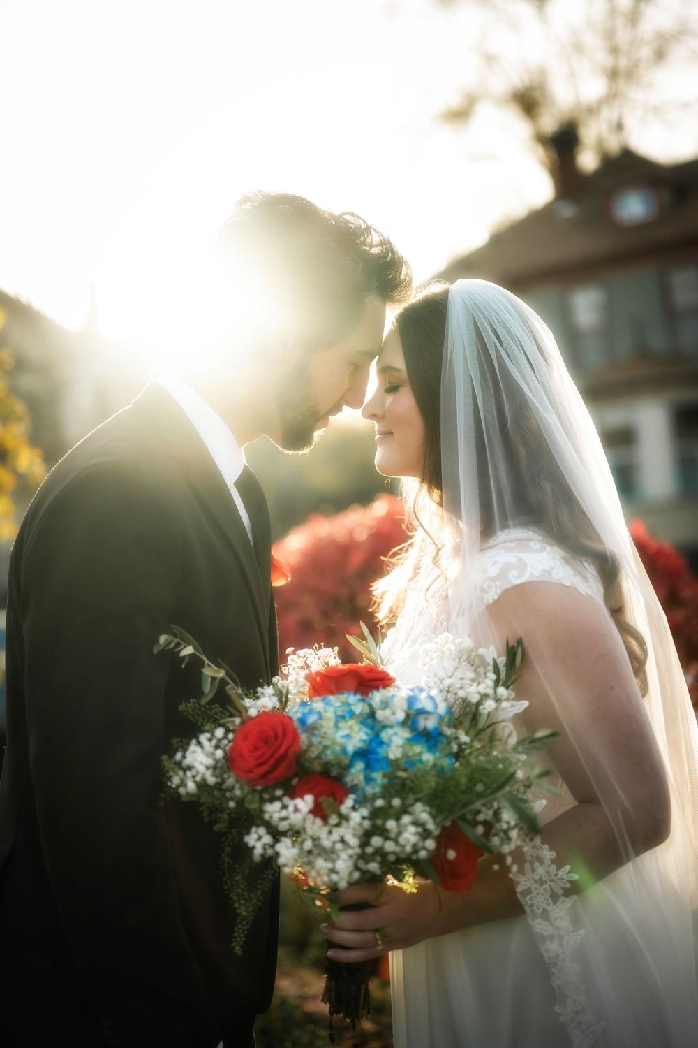 A dreamy photo of a bride and groom in the golden hour glow putting their heads together at the Roberts Mansion in Spokane Washington.