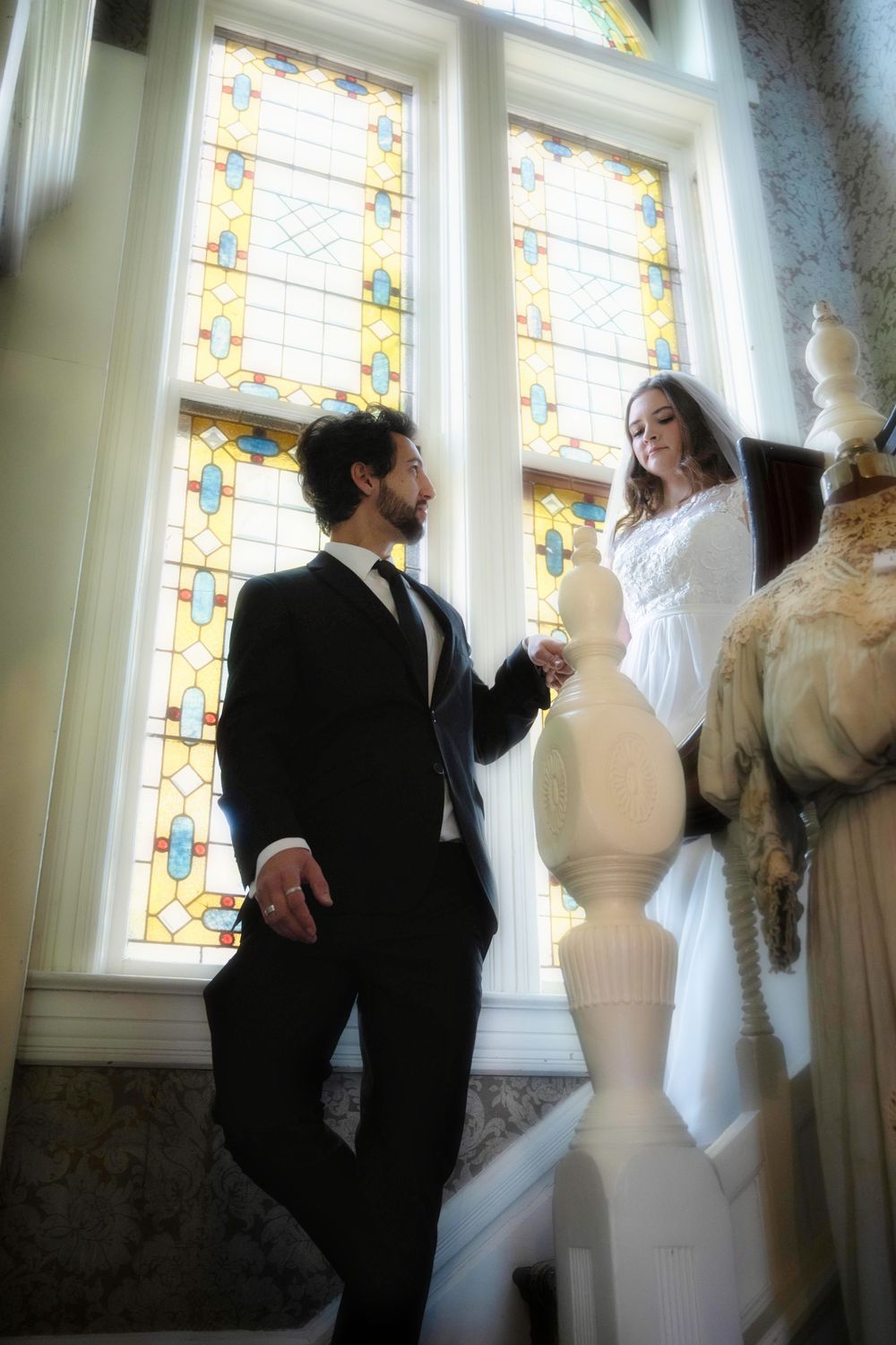 A dreamy photo of a bride and groom coming down the stairs at the Roberts Mansion in Spokane Washington.