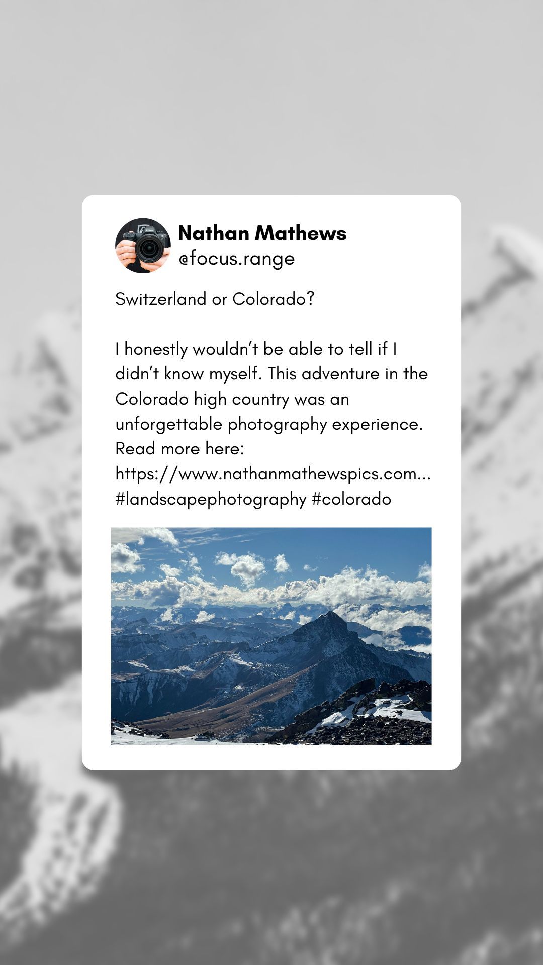 A scenic mountain landscape with snowy peaks and puffy white clouds against a blue sky in the Colorado high country.