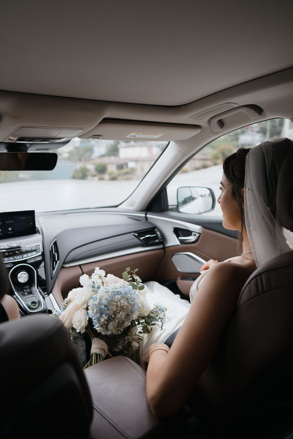 A series of shots showing a bouquet of white flowers in a car during a wedding day journey.