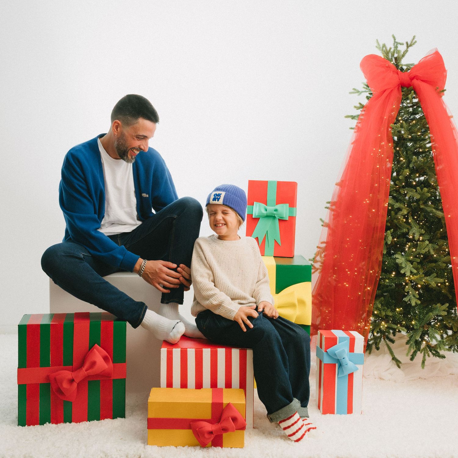 A series of festive Christmas photos showing a red sweater and large green gift boxes with yellow bows against a decorated tree.