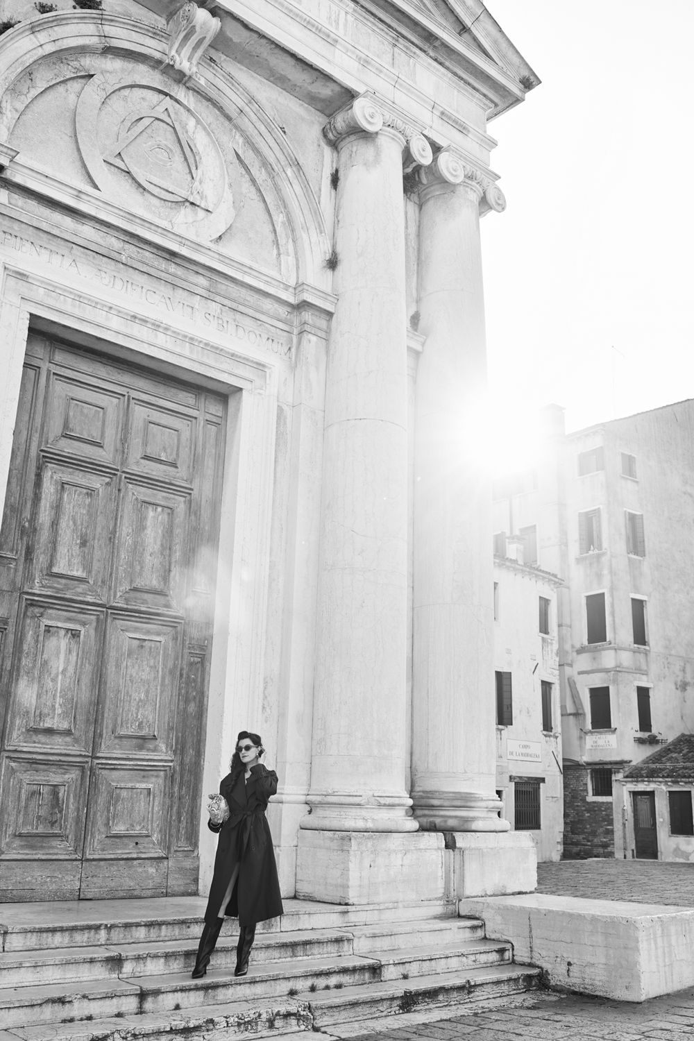 A figure stands in front of a classical white building entrance with columns and ornate doors in a four-panel sequence.