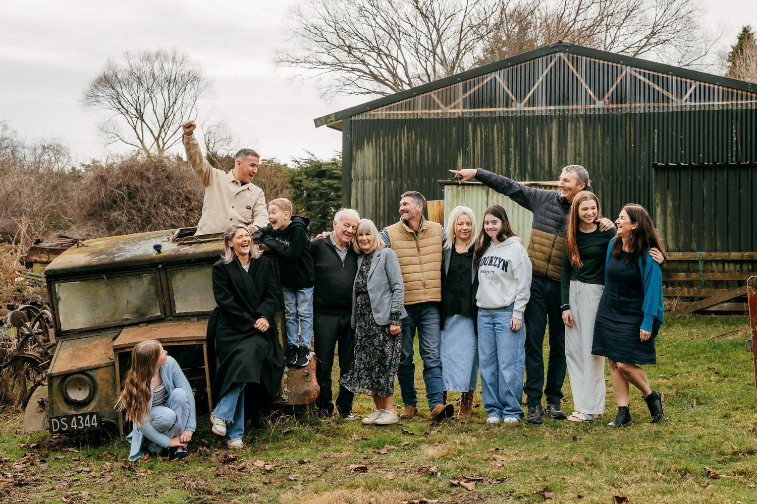 Extended family photoshoot during winter on the farm in Canterbury near Christchurch New Zealand. The family have fun around old farm truck.