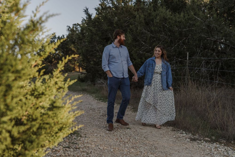 A couple strolls together on a scenic hiking trail during sunset.