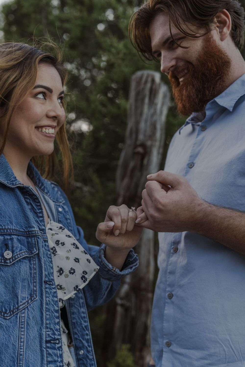 Couple in denim and blue sharing an intimate moment outdoors.