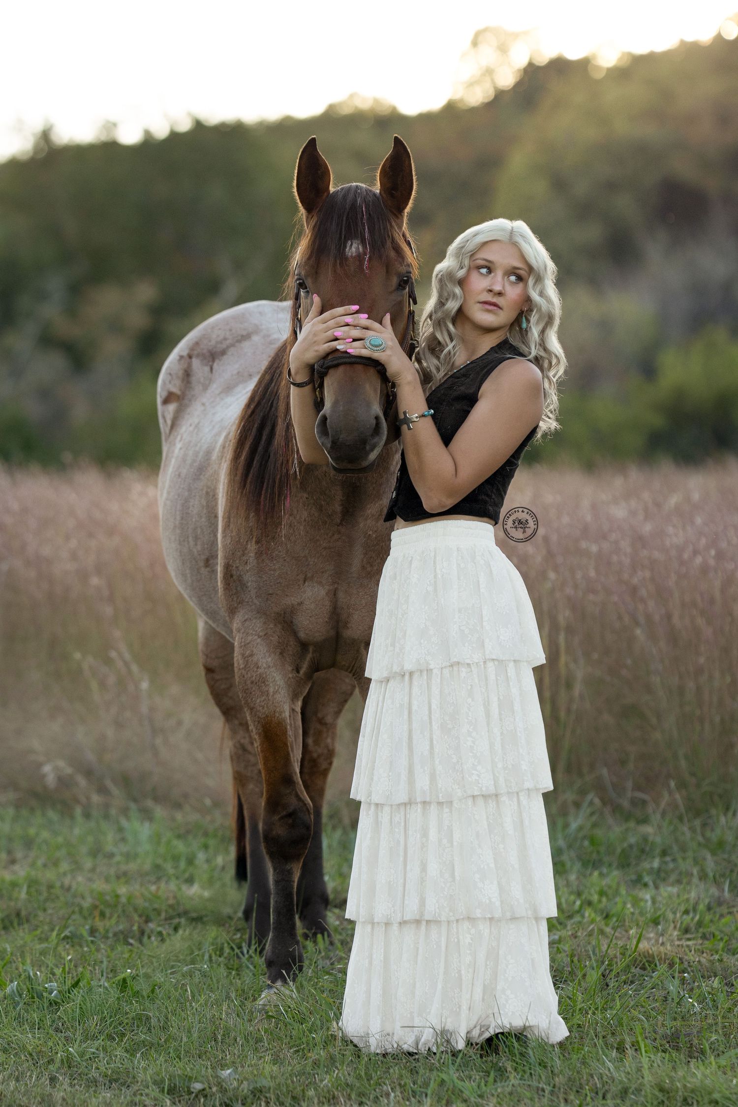 A series of photos showing a brown horse and someone in a white tiered dress standing together in a grassy field at sunset.