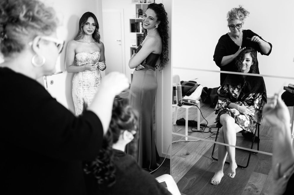 Wedding party candid moments captured in a sequence of black and white photographs.