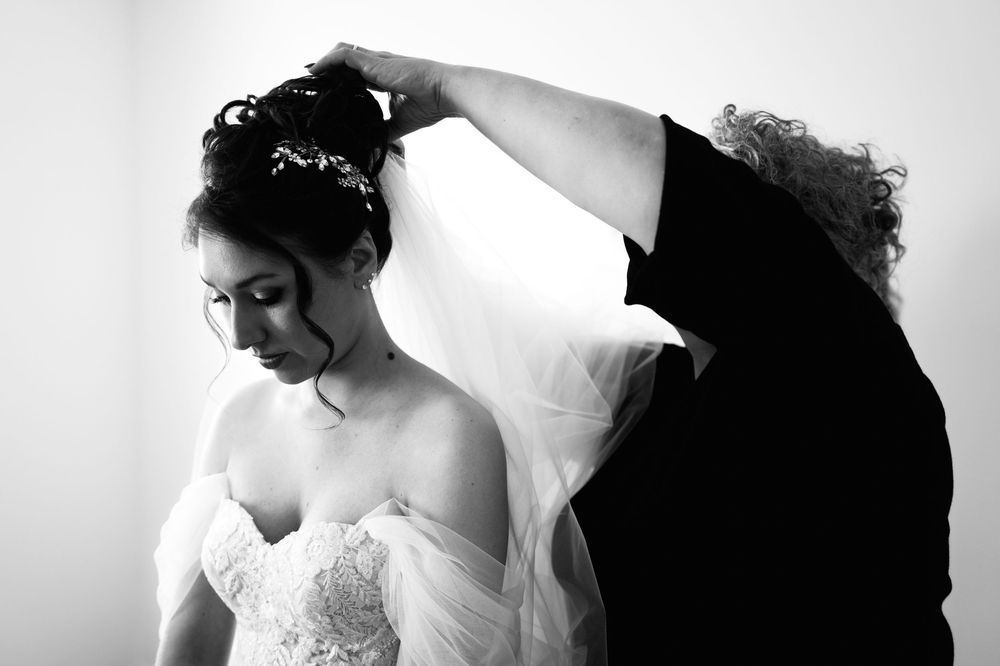 Black and white artistic wedding photography composition with soft lighting and veil details.