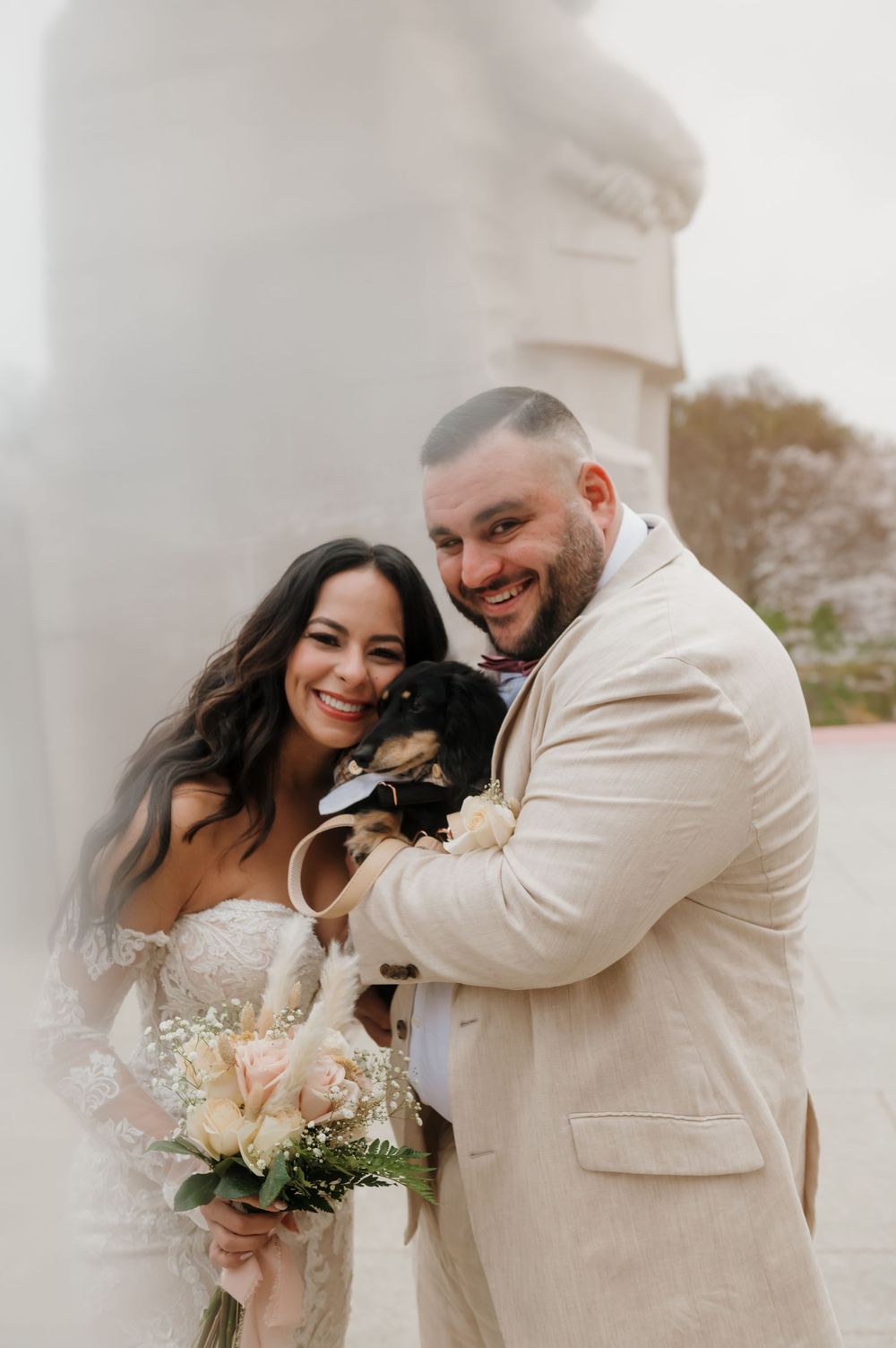 Joyful wedding couple shares candid moments by waterfront.