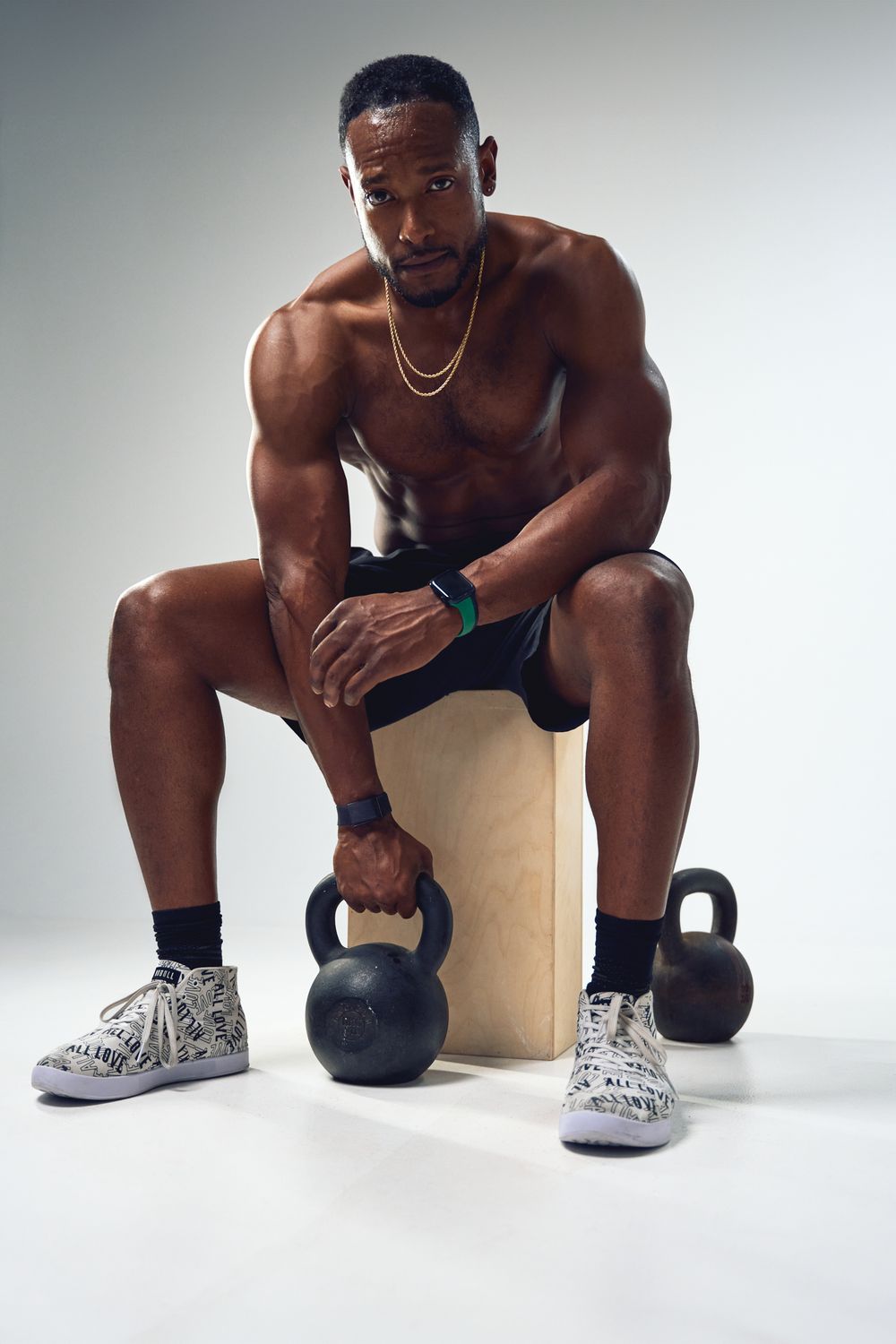 Athletic person demonstrating various kettlebell exercises in minimalist studio setting.