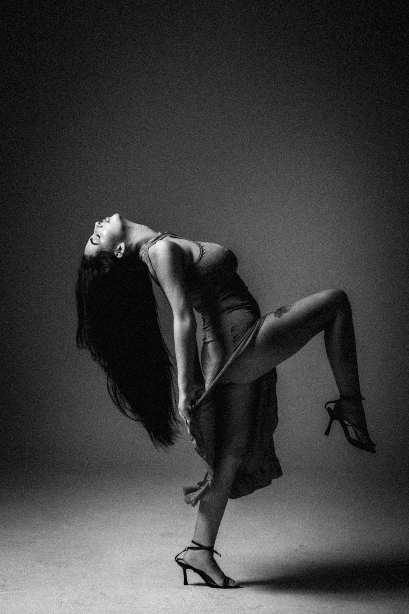 Artistic black and white dance sequence showing graceful movement and dramatic poses in moody lighting.