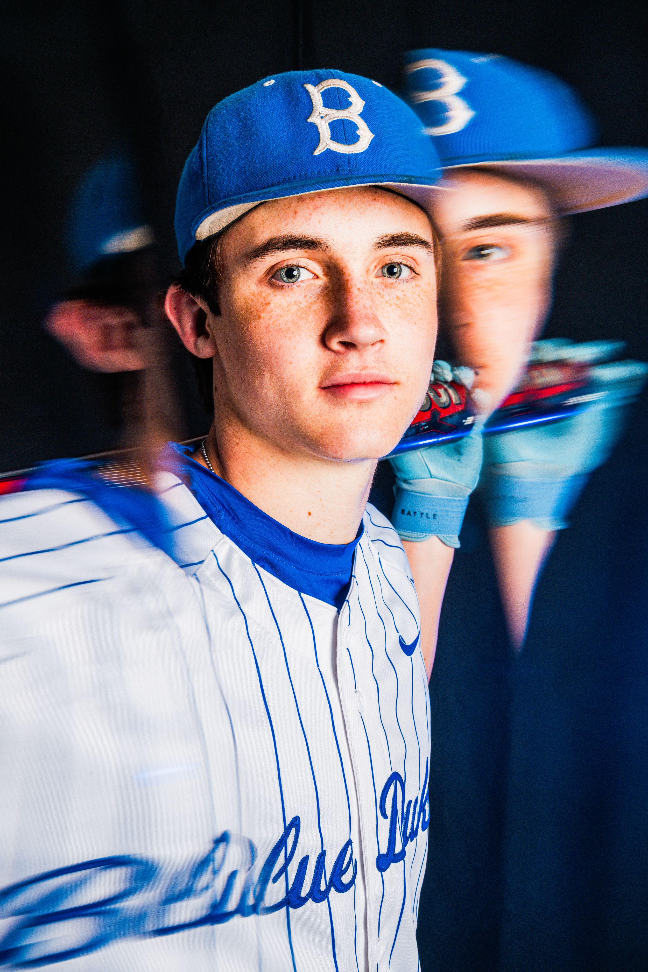 Baseball player in Brooklyn Dodgers uniform poses for a dramatic portrait with reflections in the background.