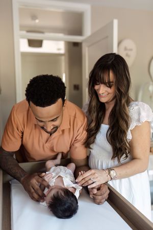 A series of tender moments showing parents interacting with their newborn baby in a bright indoor setting.