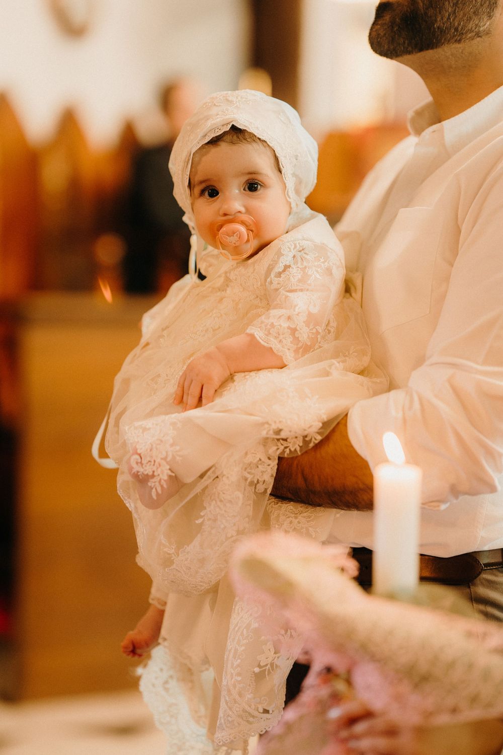 Elegant christening gown and sacred water during a Melbourne Catholic baptism, documented with detail and reverence.