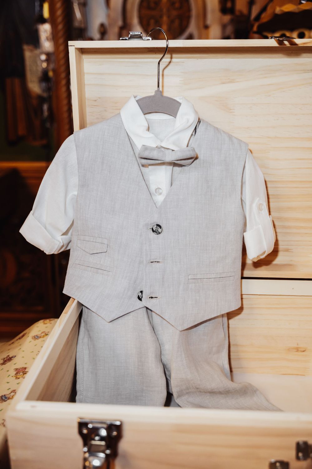 Close-up of the baby’s formal suit jacket and bow tie, beautifully captured in Melbourne after the baptism ceremony, symbolizing elegance.