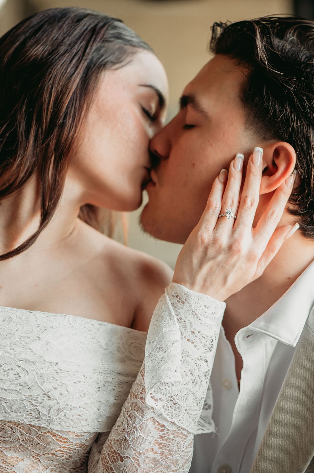 A romantic sequence of intimate wedding photos showing a couple in an elegant embrace with white lace details.