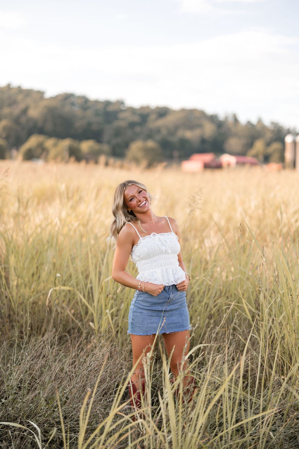 A carefree moment captured in a sunlit meadow with tall grass swaying in the late afternoon light.