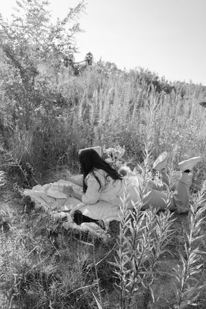 Black and white nature scene with tall grass and wildflowers.