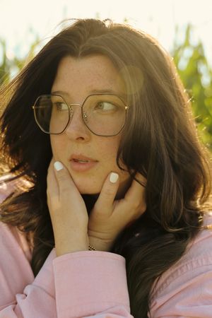 Playful closeup portraits showing expressions and emotions against a natural outdoor backdrop.