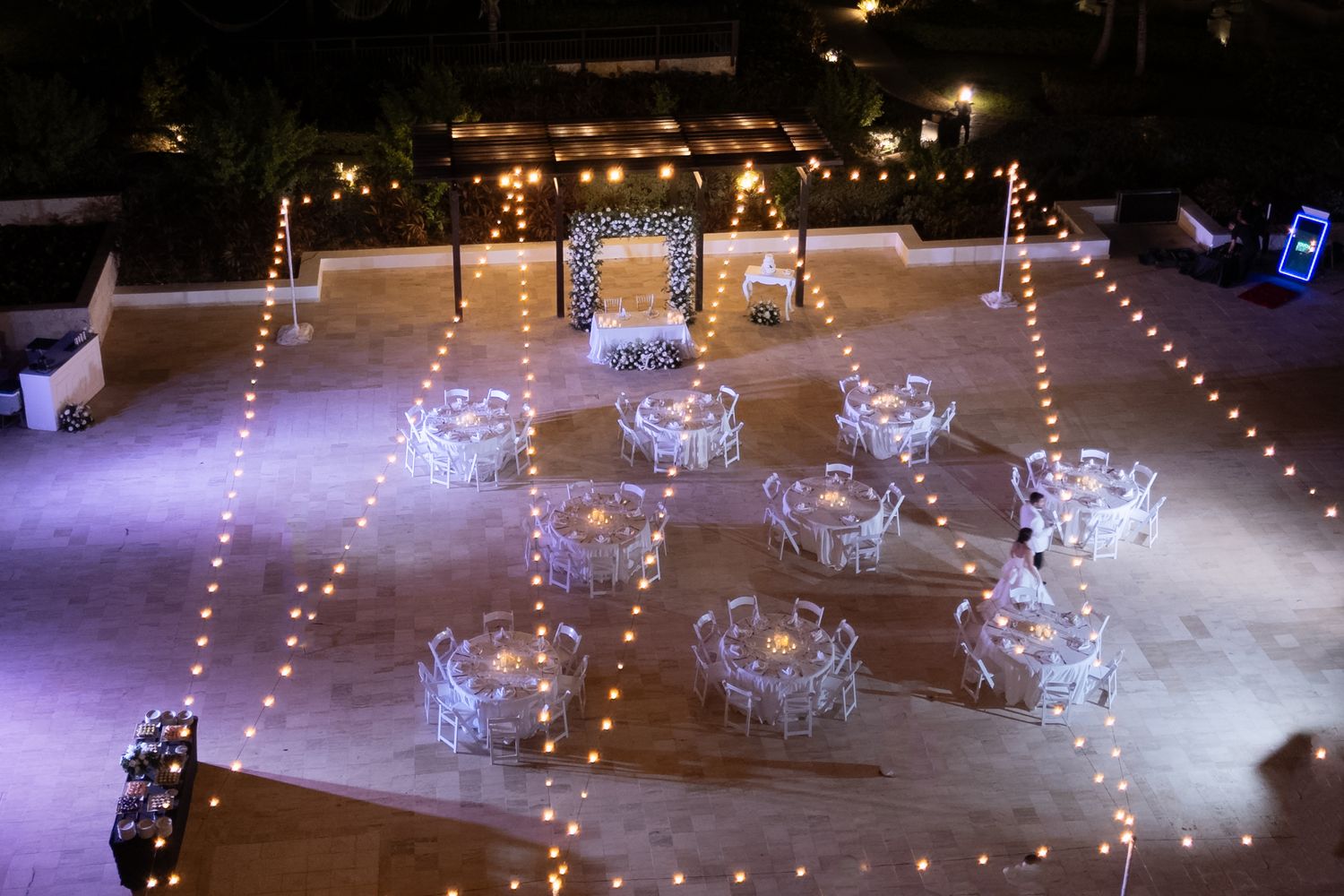 Dreams Macao Evening reception setup with illuminated string lights and elegant white table settings.