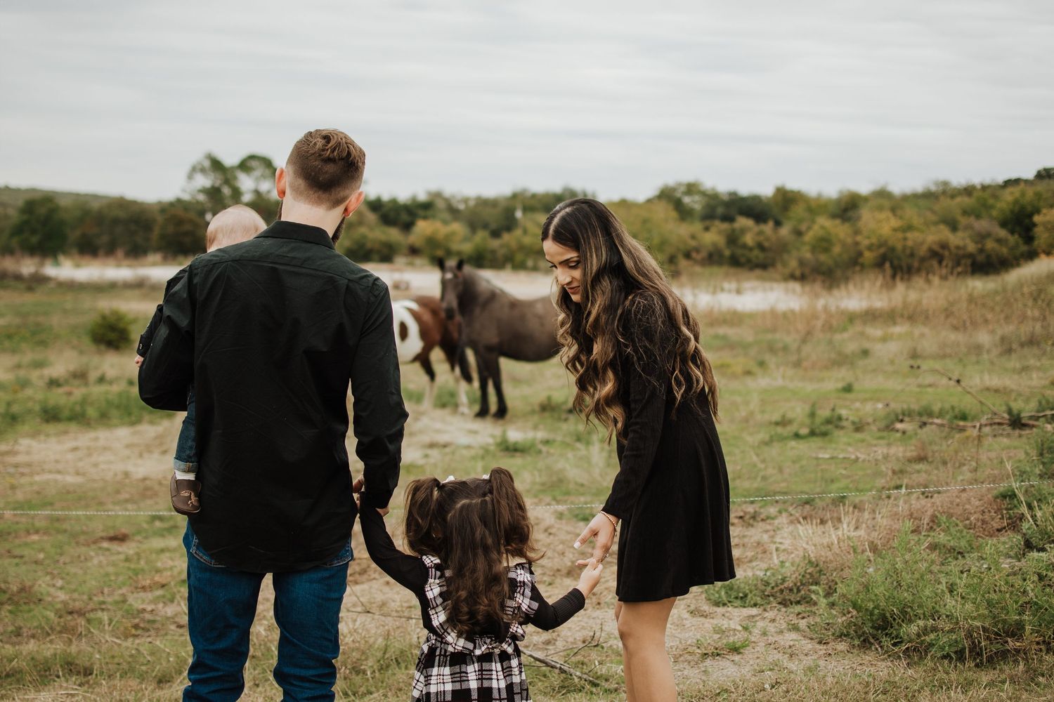Family walking together through a scenic outdoor landscape.