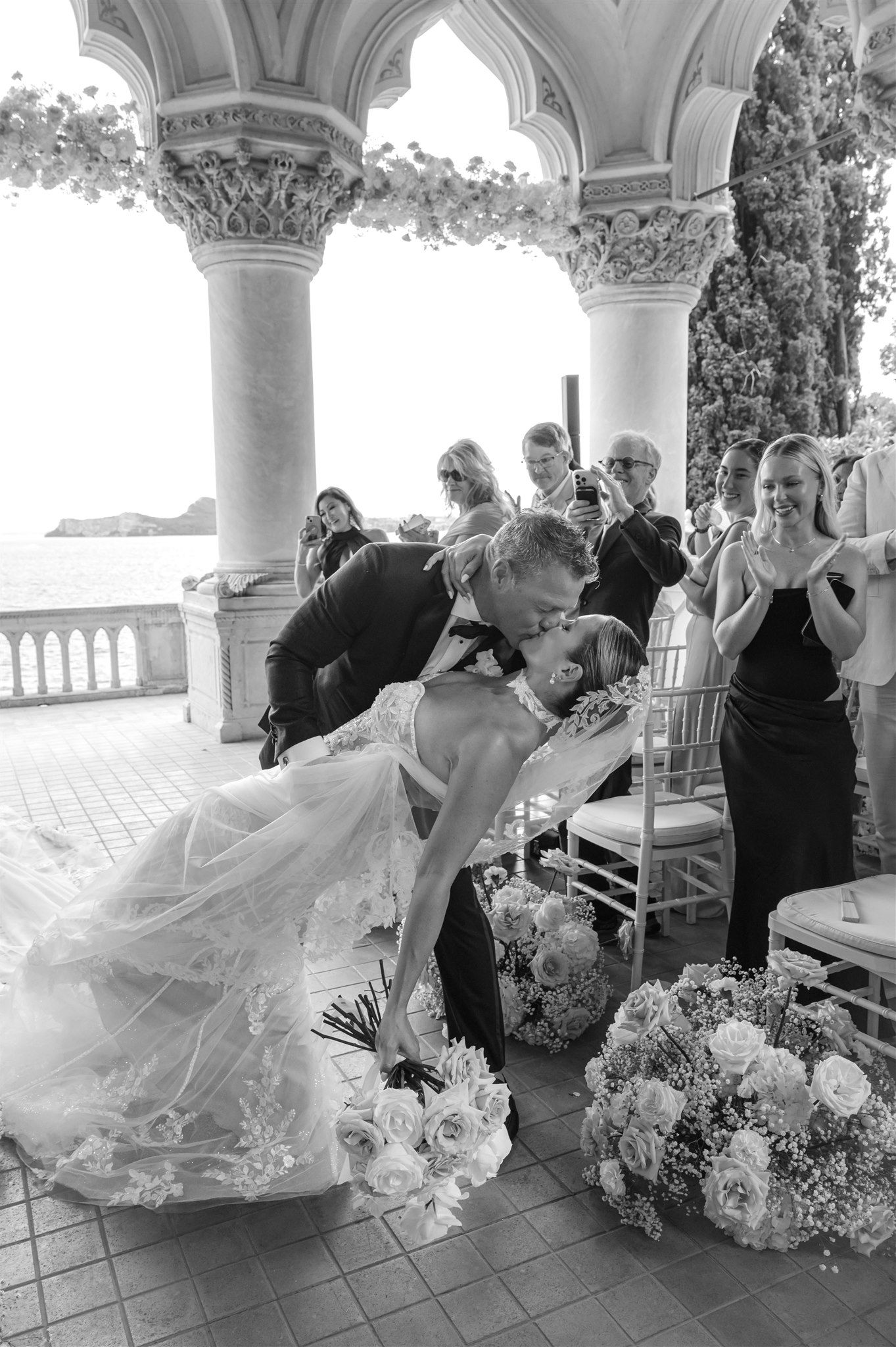 Dynamic wedding scene under columned pavilion with flowing dress movement.