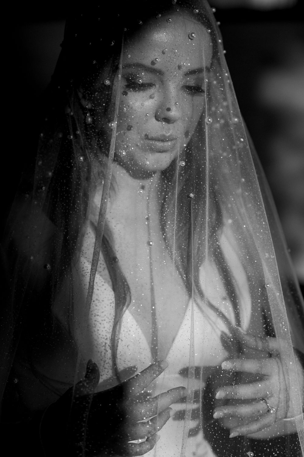Artistic black and white portrait series showing a veiled figure in soft, ethereal lighting.
