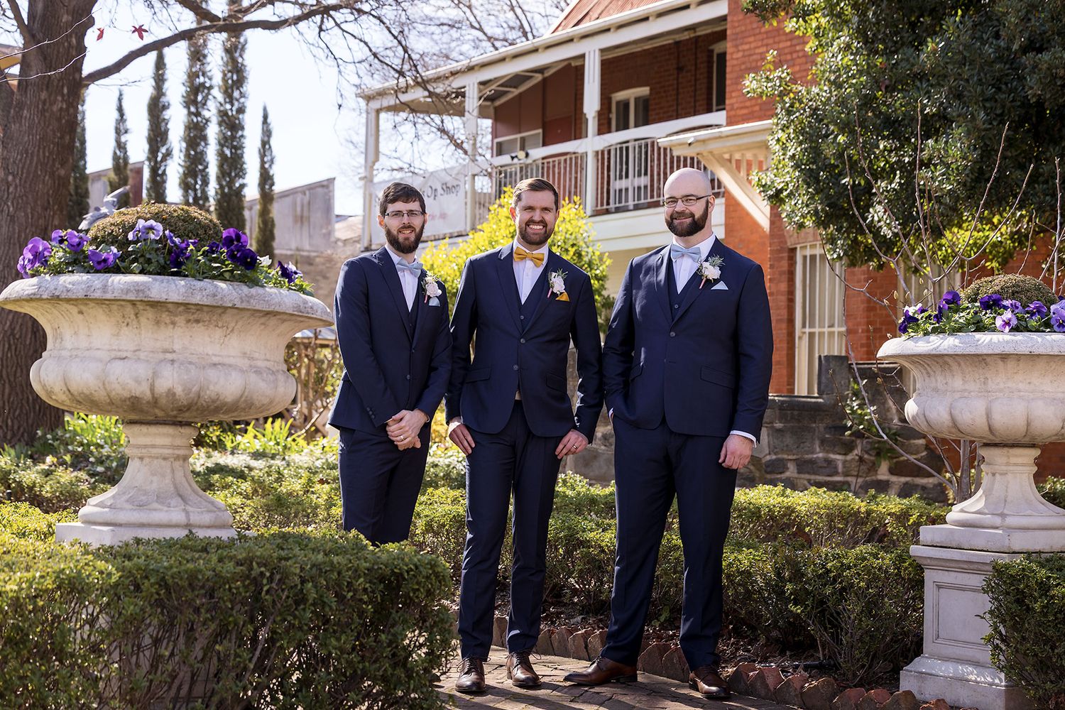 Groom and his Groomsmen wearing blue suits with Bowties and white button hole flowers at St.Matthews Church in Albury.