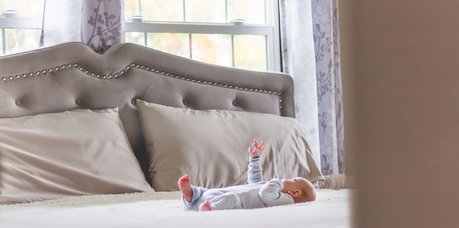Cozy bedroom scene with natural light streaming through windows.
