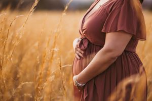 Pregnant woman in a serene maternity photo session in nature, captured by Urso Photography in the scenic outdoors of Chattanooga.