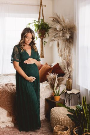 Mother-to-be glowing in a classic studio maternity session by Urso Photography.