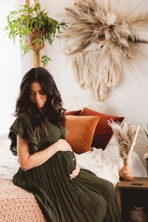 Maternity photo in Urso Photography’s studio, showcasing the beauty of pregnancy in a serene and elegant setting.