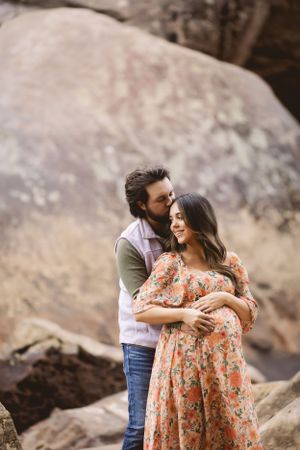 Outdoor maternity photo surrounded by fall leaves, captured by Urso Photography.