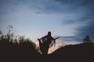 Pregnant woman in a serene maternity photo session in nature, captured by Urso Photography in the scenic outdoors of Chattanooga.